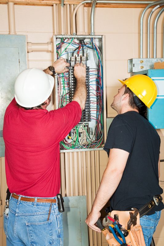 Electrician Working on Circuit Breaker